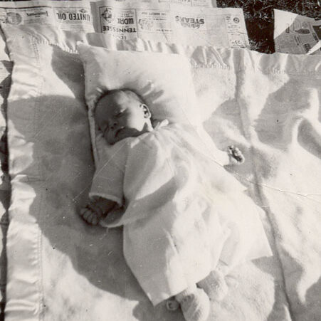Baby Billy Windsor on pallet on grass in 1948