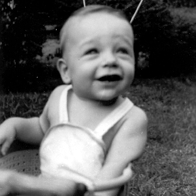 Billy Windsor looking up from stroller in 1949