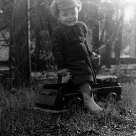 Billy Windsor in hat playing on riding truck in Columbus Georgia in 1950