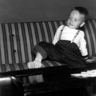 Billy Windsor playing on striped couch at 2222 Buena Vista Road in Columbus Georgia